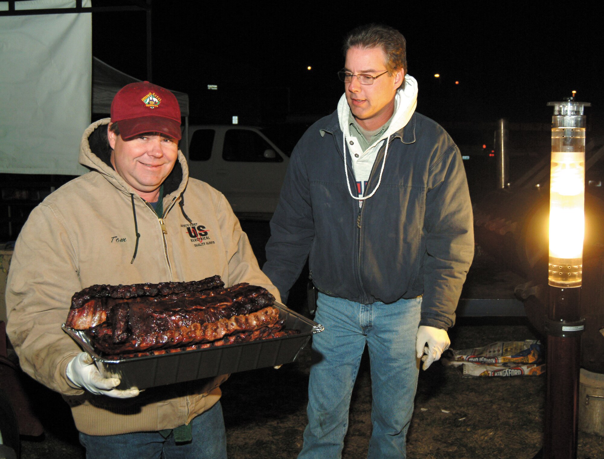 Tom Henderson and Steve Frerichs were among the volunteers cooking food at 3:30 a.m. for the 442nd Fighter Wing Family Day picnic Oct. 14, 2006.  (U.S. Air Force photo/Master Sgt. Bill Huntington)