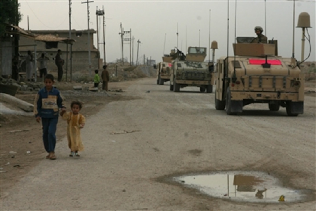 U.S. Marines with Mobile Integrated Training Team of 2nd Brigade, Regimental Combat Team 5, I Marine Expeditionary Force conduct a patrol in Fallujah, Iraq, Oct. 28, 2006, during an Iraqi army-led cordon and search operation. 