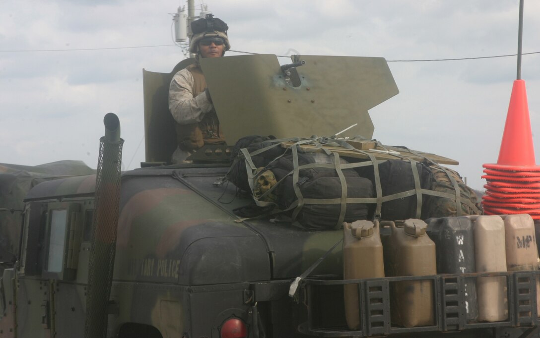 Marines of the 26th Marine Expeditionary Unit unload from the ships of the Bataan Strike Group in order to construct a Logistics Supply Area to support land operations during the Composite Unit Training Exercise, Nov. 2, 2006.  (Official USMC photo by Lance Cpl. Aaron J. Rock)