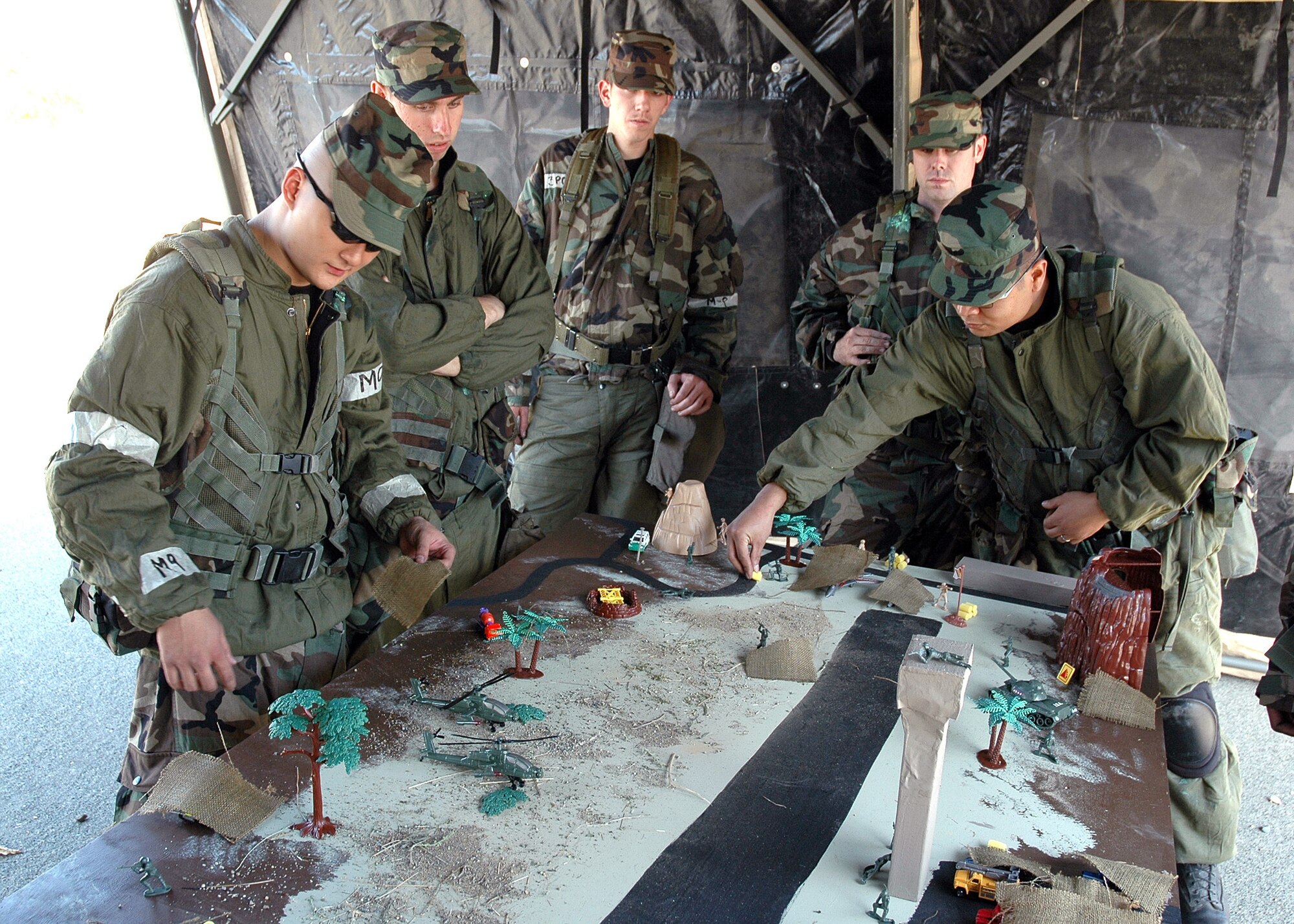 Air Force Reservists Airman 1st Class Jeffery Dunn, Senior Airman Michael Riggs, Airman 1st Class Cody J. Nuehring, Airman 1st Class Jacob Hunter, and Senior Airman Gary Gaspar, all from the 940th Security Forces Squadron, participate in a tabletop camouflage and dispersal task "ATSO Challenge," the 940th Mission Support Group's rapid-fire combat skills exercise Oct. 14, 2006 at Beale Air Force Base, Calif.   The event provided refresher training in basic ground combat skills by rotating eight teams of eight Airmen through eight task-oriented training stations.  (U.S. Air Force photo/Maj. Robert Couse-Baker)
