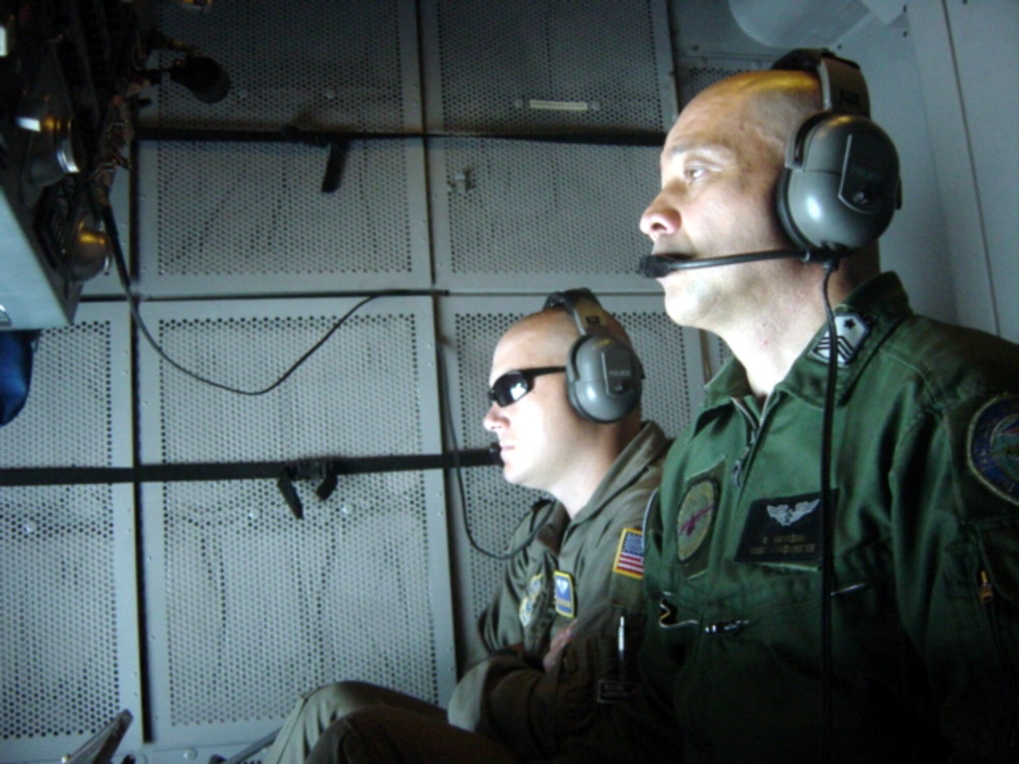 Staff Sgt. Zach Fleming [left], 6th Aerial Refueling Squadron instructor watches as Master Sgt. Randy Kawasaki, Japan Air Self Defense Force, attempts aerial  refueling contact during a KC-10 training mission. (Courtesy photo)