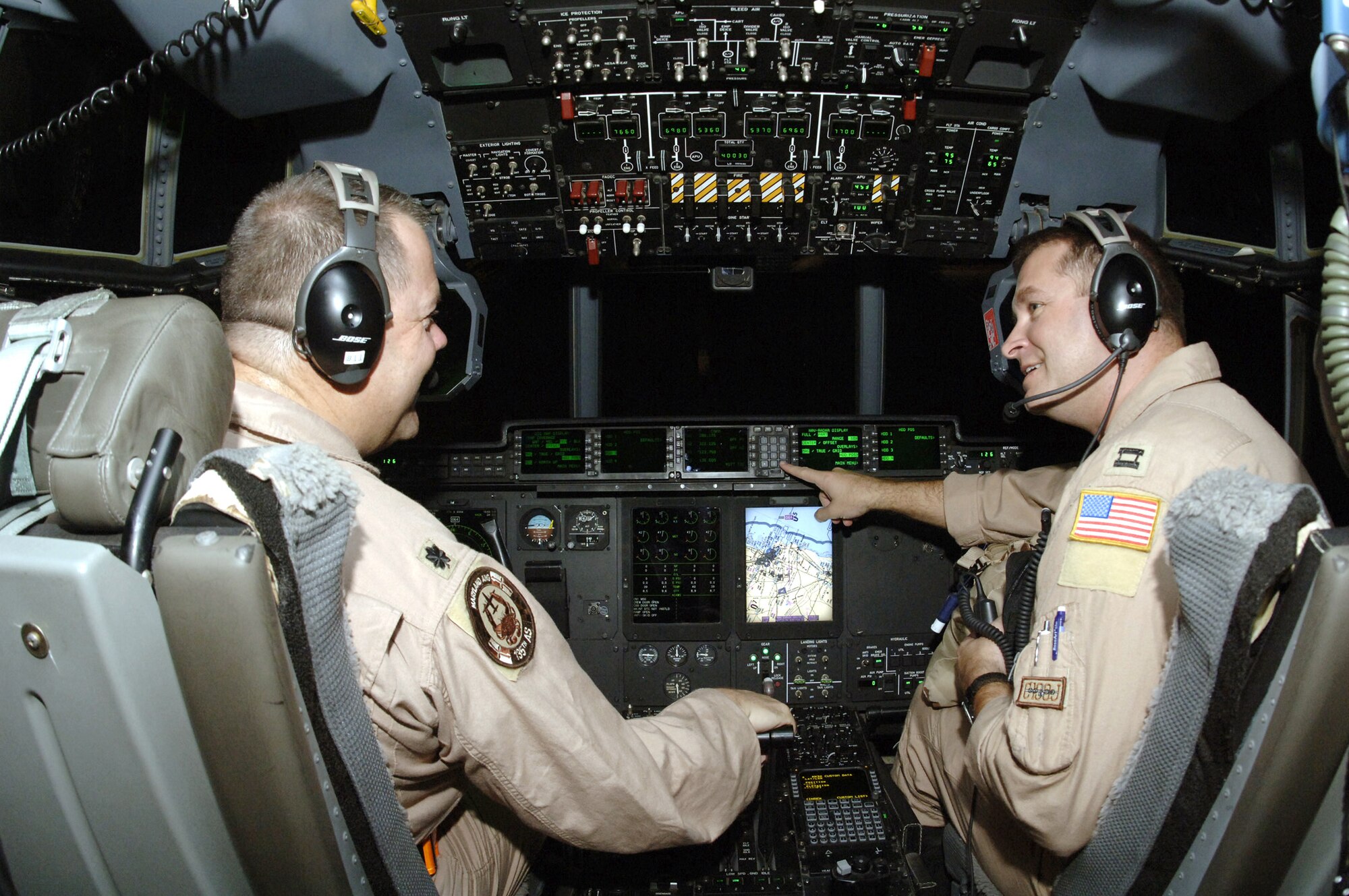Lieutenant Col. Tim Robins and Capt. Frank Noe, both of the 746th Expeditionary Airlift Squadron, discuss their evening's flight plans. (U.S. Air Force photo/Senior Airman Ricky Best) 