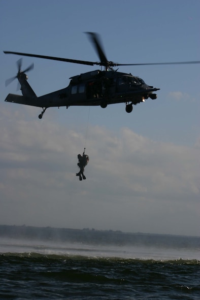 MACDILL AIR FORCE BASE, Fla. -- A pararescueman and a “downed pilot” are hoisted back up to an HH-60G Pave Hawk after the pilot is rescued during Exercise Atlantic Rescue ’07 at MacDill Air Force Base, Fla., Oct. 31.  More than 300 23rd Wing Airmen are testing their combat search and rescue skills during the exercise, which is dedicated to providing CSAR-focused training while integrating airborne command and control with various assets throughout the wing. (Photo by Tony Banks)