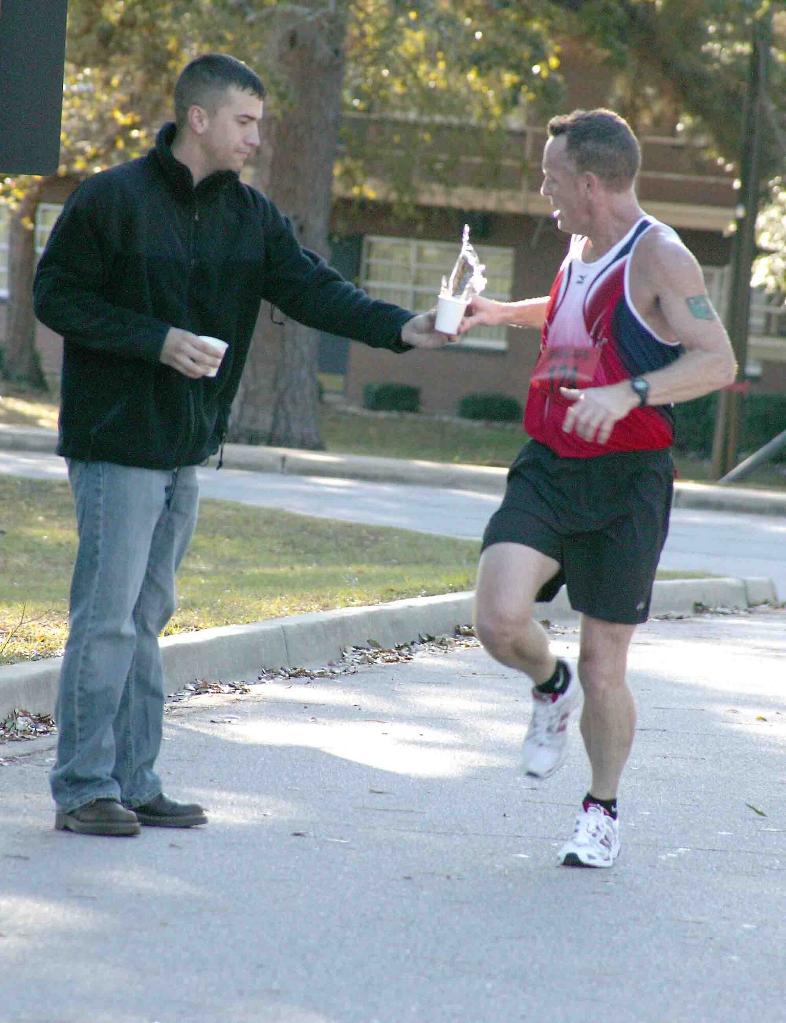 Tech. Sgt. Thomas Halpin, 609th Air Communications Squadron, grabs a cup of water at the halfway point during a half marathon Oct. 28. Sergeant Halpin won first place in the men's division with a time of 1:29:39. (U.S. Air Force photo/Senior Airman John Gordinier)