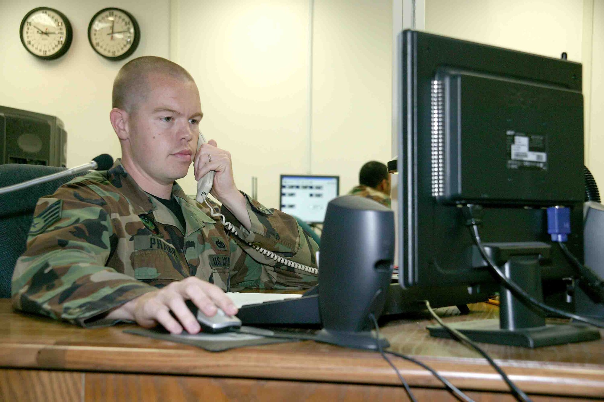 Staff Sgt. Jonathon Pharr, 20th Maintenance Operations Squadron Maintenance Operations Center controller, verifies aircraft status Oct. 16 with the 77th Fighter Squadron production supervisor. (U.S. Air Force photo/Senior Airman John Gordinier)