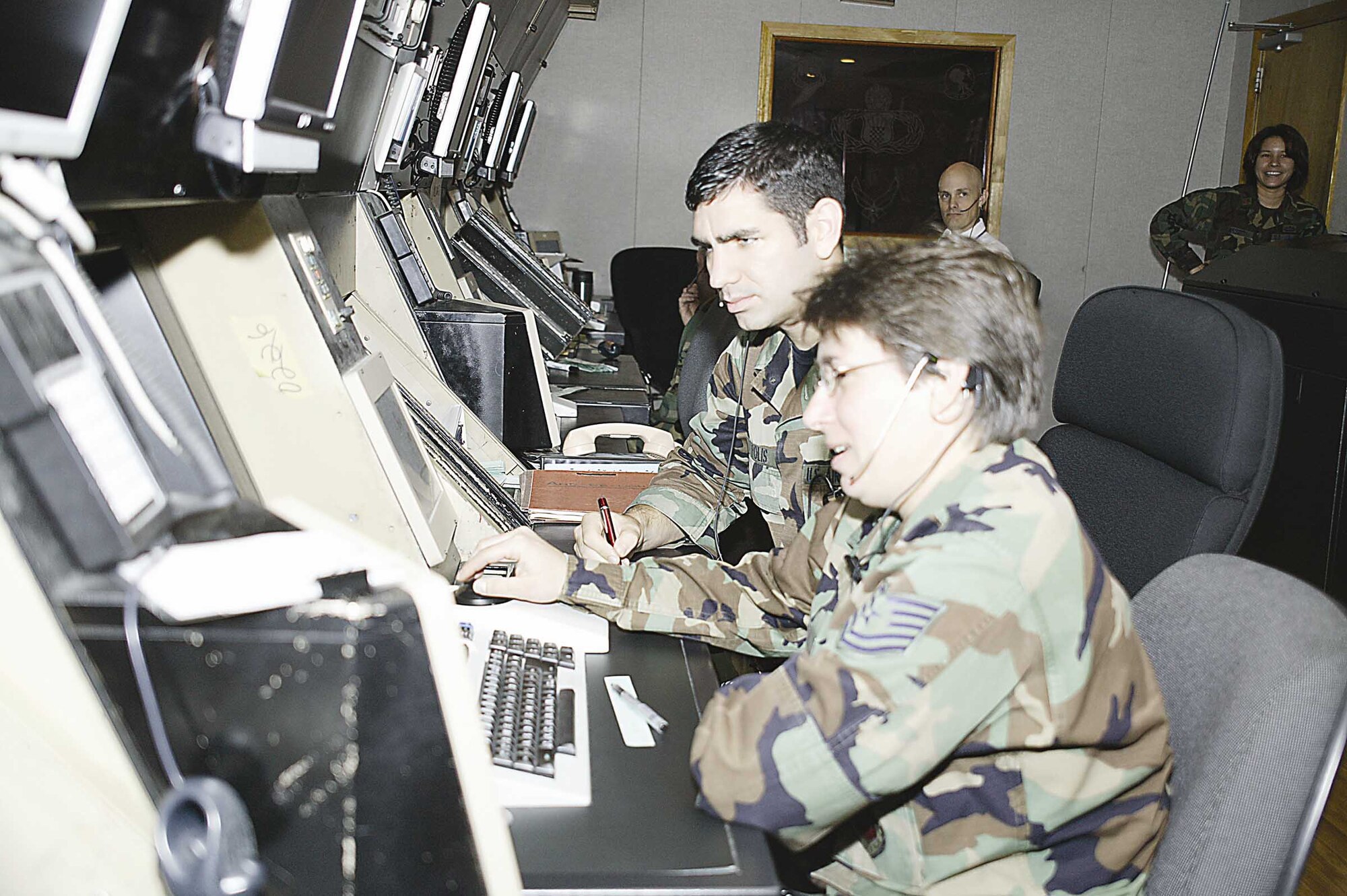Tech. Sgt. Lisa Melton, 20th Operations Support Squadron air traffic controller, serves as a wingman to Senior Airman Jonathan Polis, 20th OSS air traffic control apprentice, during observation of approaching aircraft Nov. 1. Shaw Airmen will observe Wingman Day on Nov. 9. The goal is to strengthen the morale and welfare of the wing by devoting time to buidling relationships between co-workers, examining organizational strengths and vulnerabilities, and planning for the coming year. (U.S. Air Force photo/by Senior Airman Holly MacDonald)