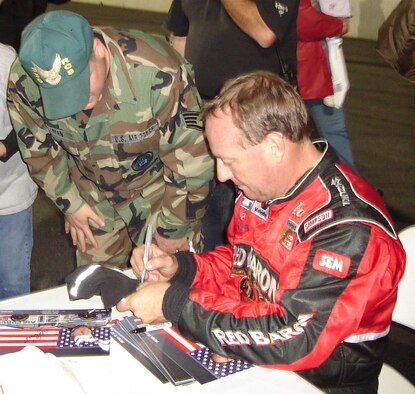 CECIL, Ga. – Staff Sgt. Mark Hallman, 336th Recruiting Squadron at Moody Air Force Base, Ga., takes a moment to get an autograph from Ken Schrader, the Air Force NASCAR driver, prior to the Premier Racing Association’s Big Car 100 series race Oct. 25 in Cecil, Ga.  The recruiting squadron set up its F-16 engine trailer and “Raptor” specialty vehicle outside the track for race fans to get an up close look at Air Force technology. (US Air Force photo/Tech. Sgt. Sonny Cohrs)