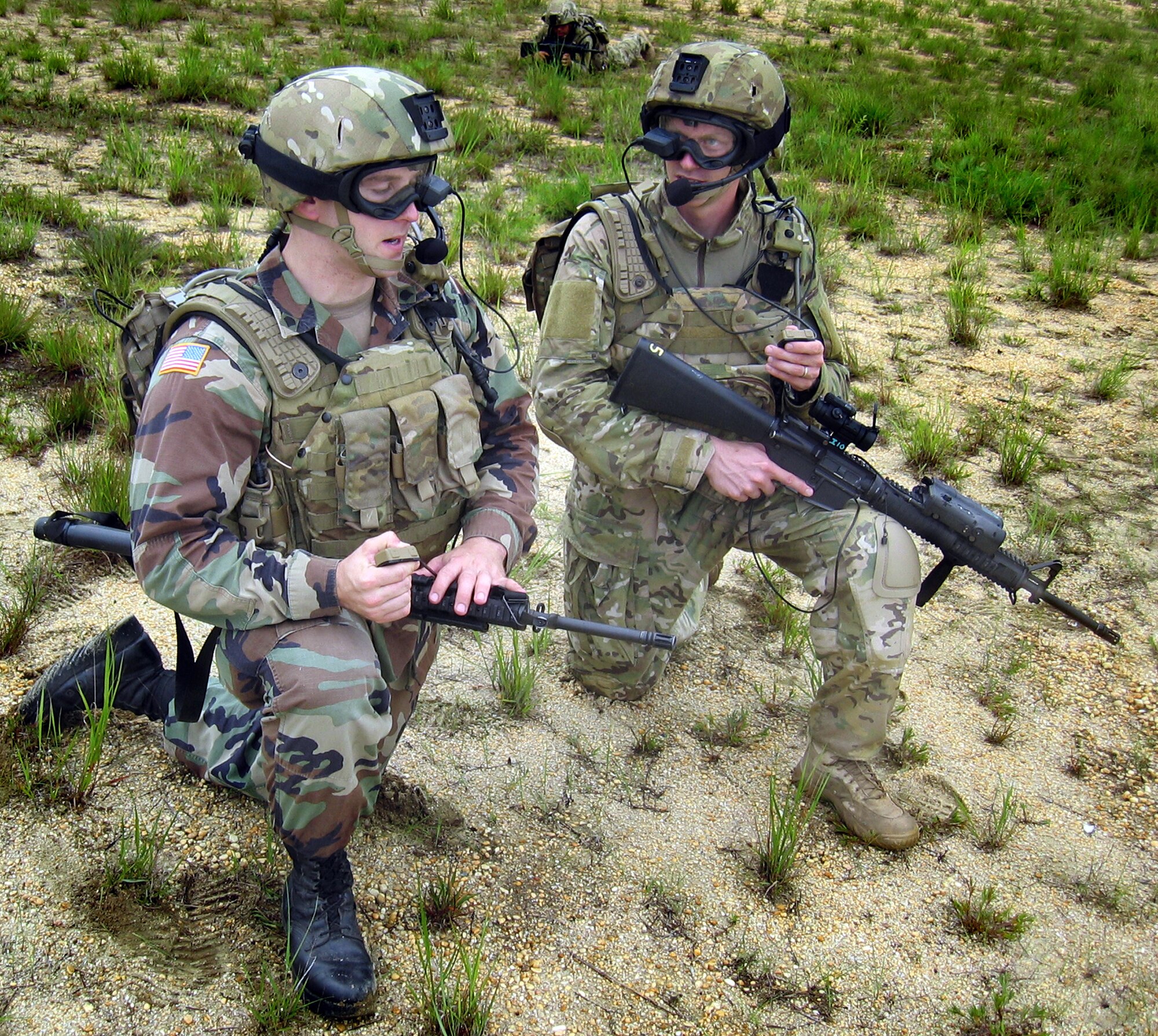 Army Spc. Chad Tobin (left) and Staff Sgt. Stephan Simmins participate in an On-The-Move training exercise in June at Fort Dix, N. J. The exercise featured Air Force technology applied to support the Army?s Future Force Warrior concept, including a goggle-mounted display, a hand-held mouse that activates push-to-talk personal computer voice command software, a backpack personal computer and power system, and rifle-mounted laser range finder. (Courtesy photo/David Darkow) 
