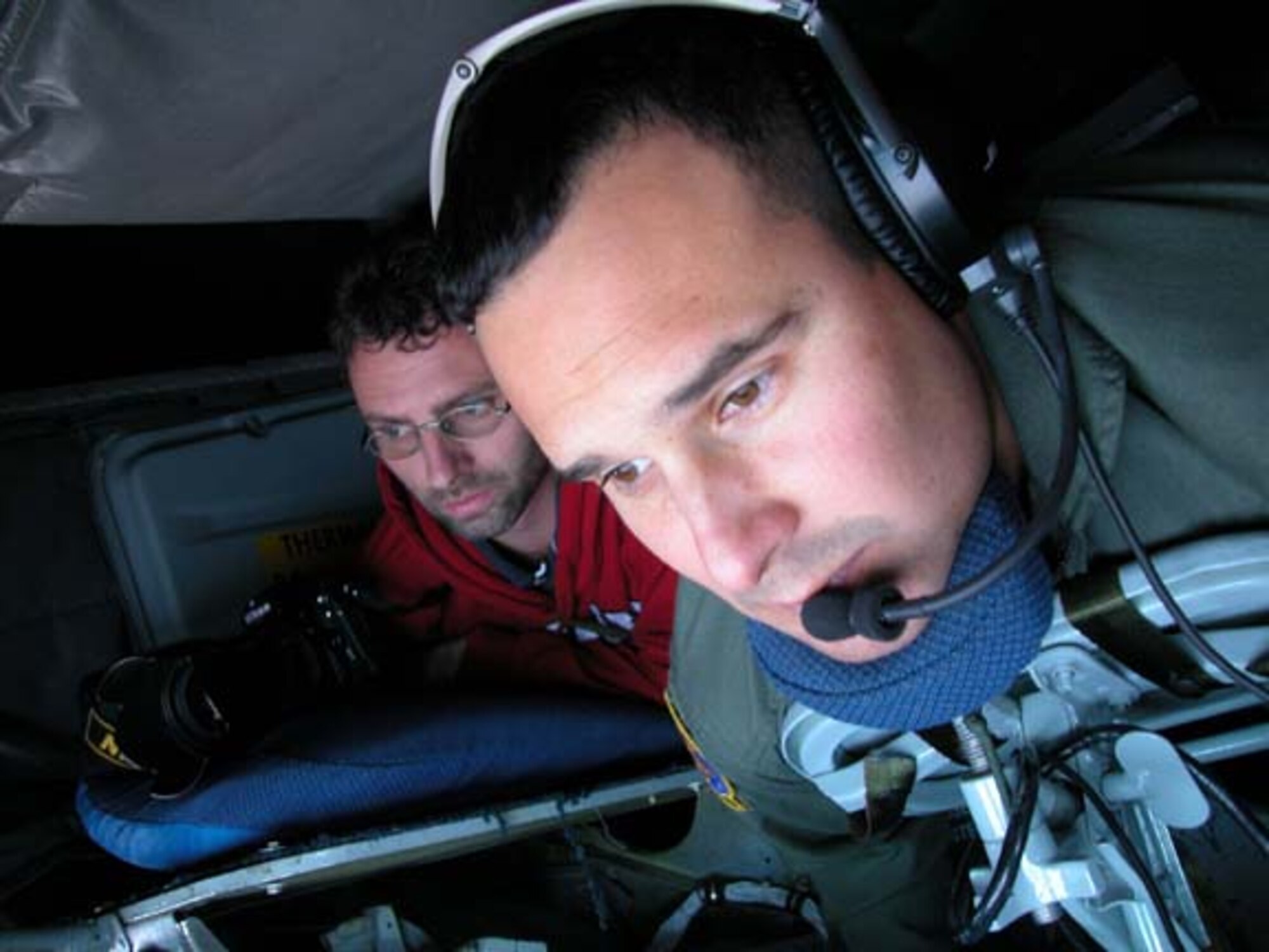 GRISSOM AIR RESERVE BASE, Ind -- Rob Edwards, a photographer with the Peru Tribune, watches as Staff Sgt. Anthony Krisher, a boom operator with the 74th Air Refueling Squadron; refuels an RC-135 based out of Offutt AFB, Neb., during a mission on Oct. 31. U.S. Air Force photo/Tech. Sgt. Doug Hays)