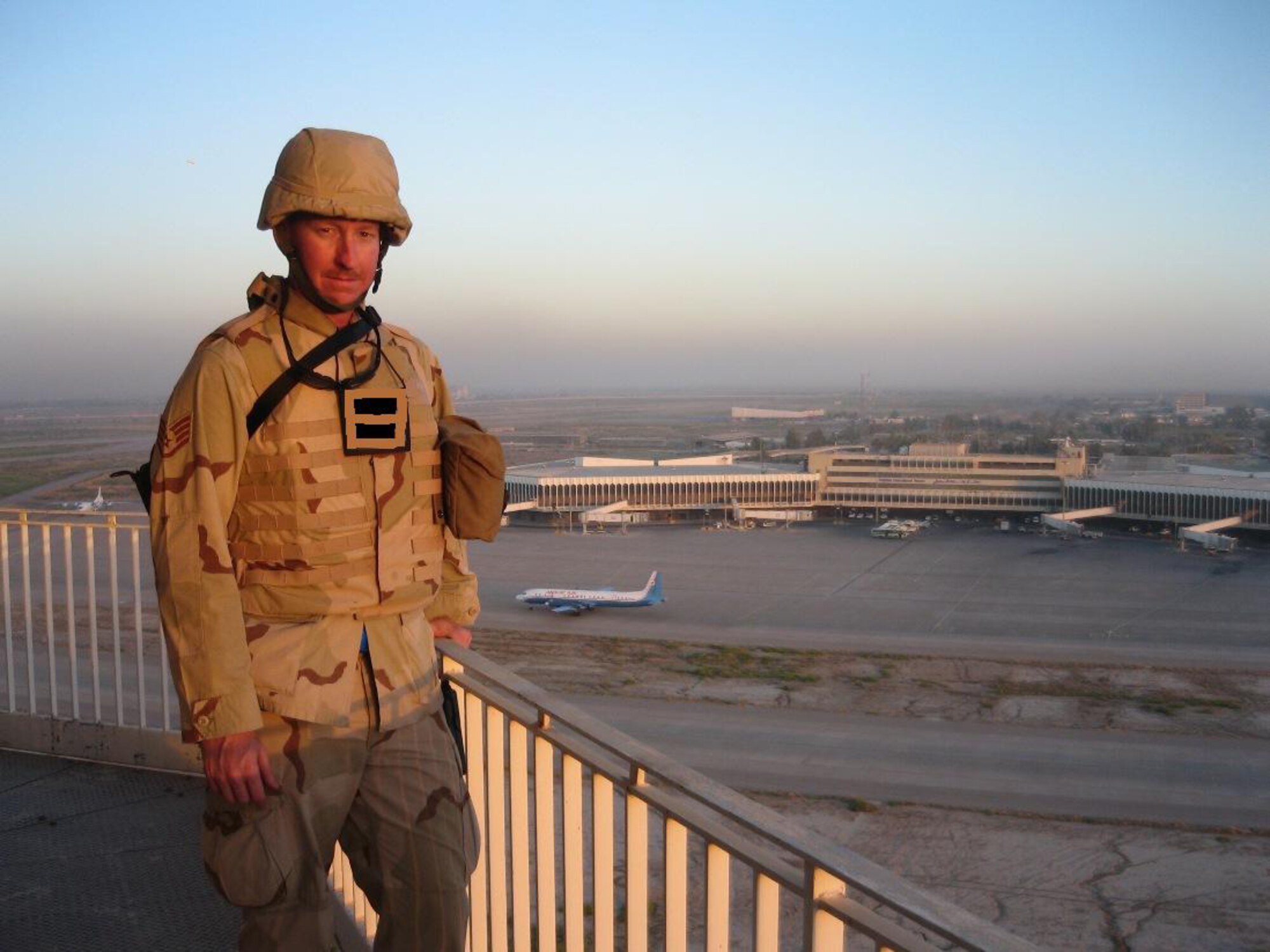 Staff Sgt. Charles Alford, 716th Communications Flight poses for a picture in front of Baghdad Interational Airport while deployed there. On this deloyment Sergeant Alford also went to Kirkuk Air Base and is now working at Sather Air Base, Baghdad International Airport. The 716th Communications Flight is assigned to the 916th Air Refueling Wing, Seymour Johnson Air Force Base, NC.