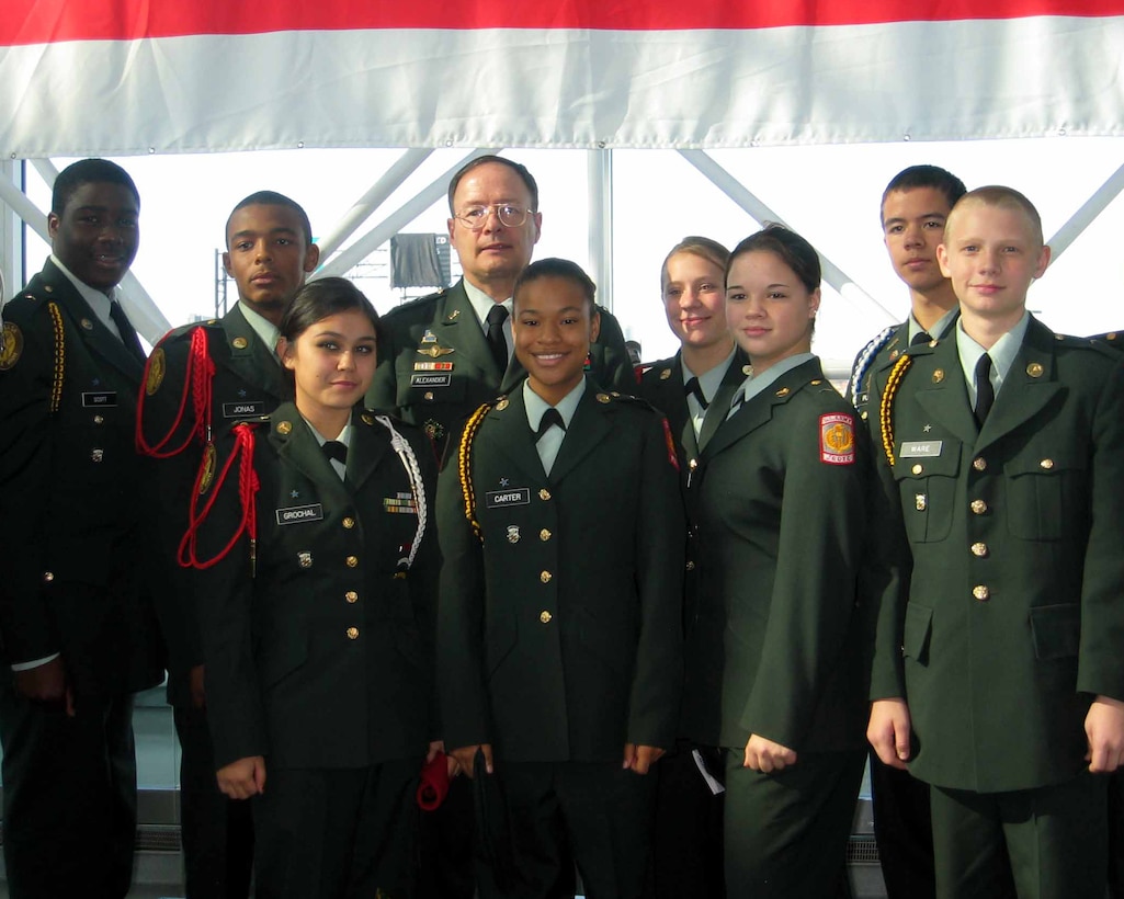 Army Lt. Gen. Keith B. Alexander (center), director of the National Security Agency at Fort Meade, Md., poses with cadets from Meade High School's Junior ROTC program Nov. 2 during the third annual "Salute to Veterans and Military Families" at Baltimore Washington International Thurgood Marshall Airport. Photo by Donna Miles