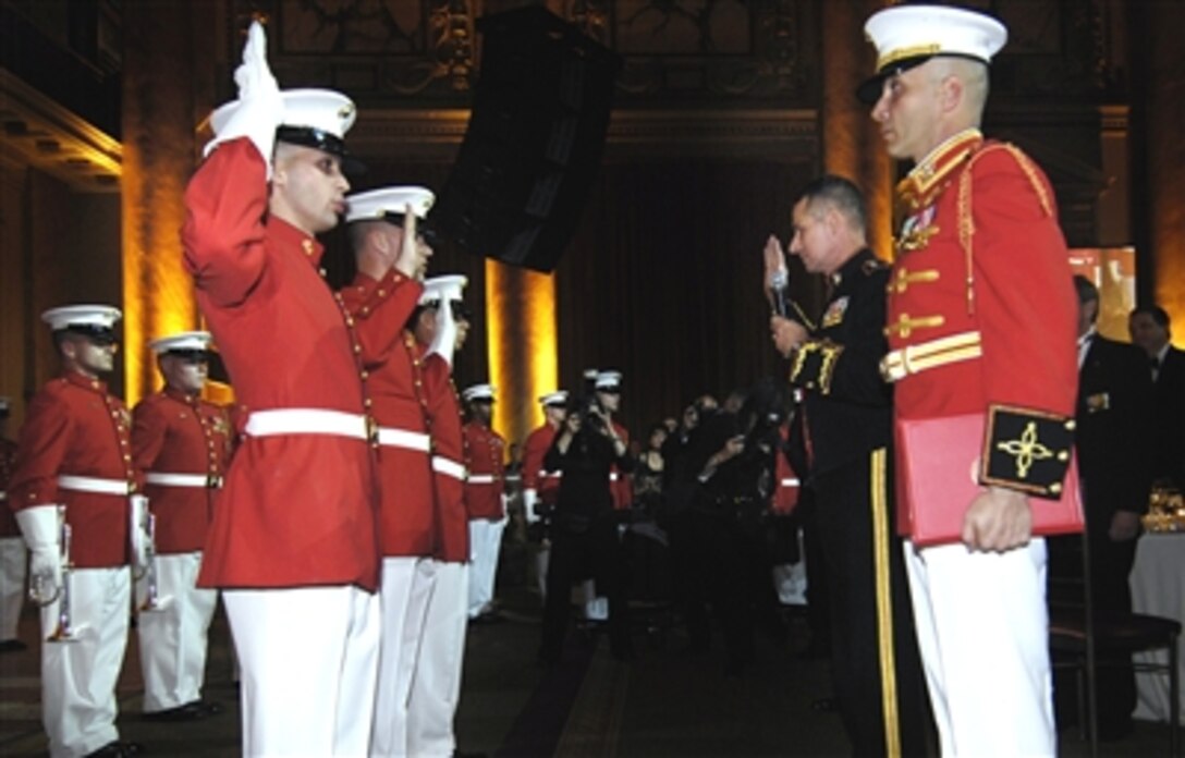 Three members of the U.S. Marine Drum and Bugle Corps are readmitted the oath of enlistment by the Chairman of the Joint Chiefs of Staff Marine Gen. Peter Pace after performing for the audience at the annual Marine Corps Birthday Ball in New York City, Nov 1, 2006. 