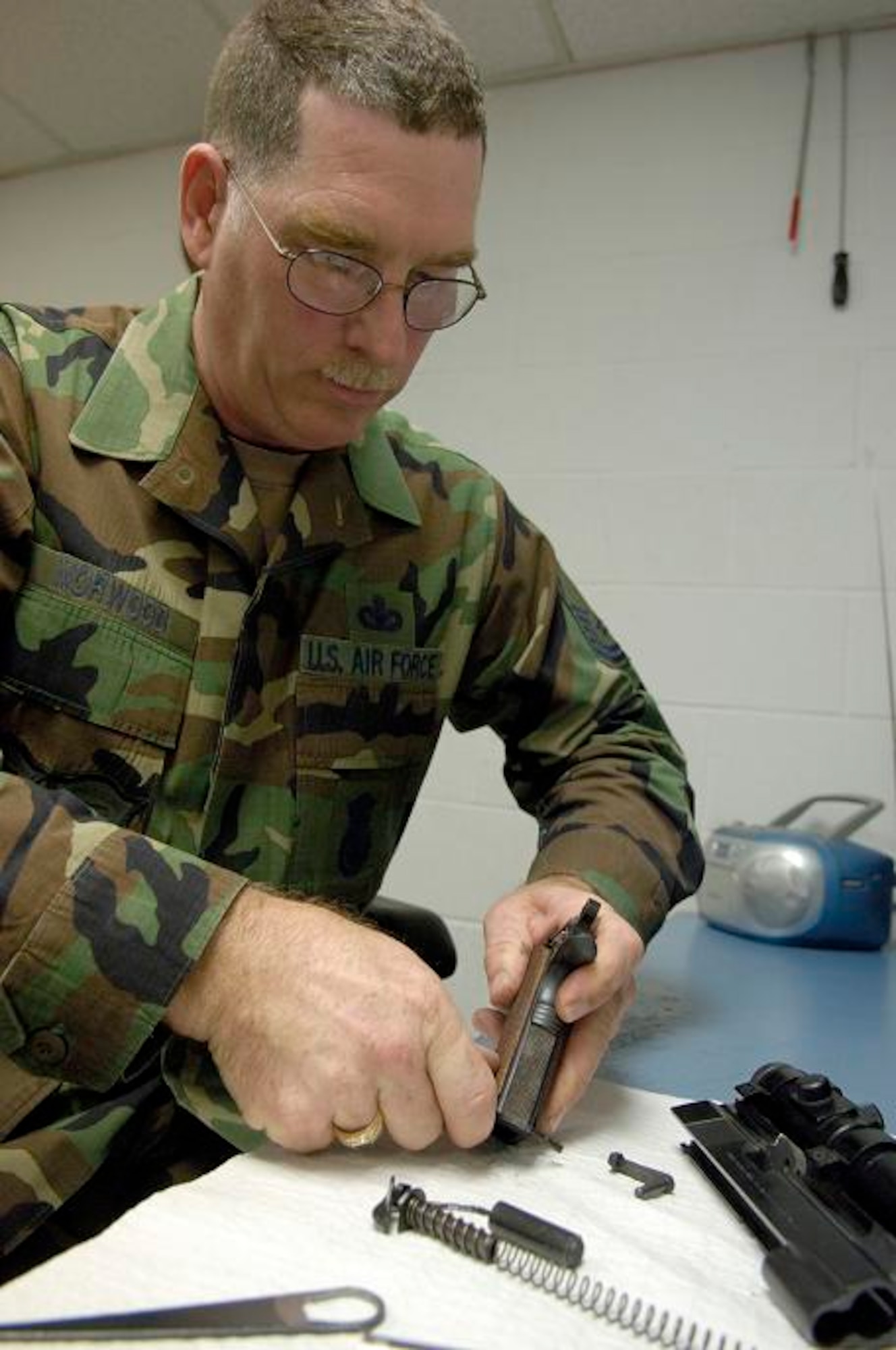 Master Sgt. Daniel Norwood disassembles a 45-caliber centerfire pistol for inspection.  Sergeant Norwood, who is a member of the Arkansas Air National Guard, is the Air Force's only military gunsmith.  (U.S. Air Force Photo/Master Sgt. Jack Braden)