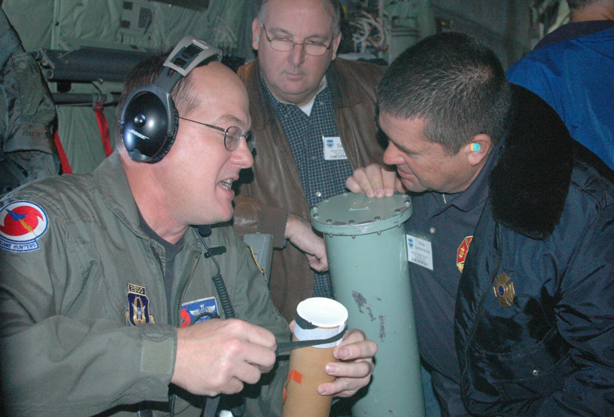 Employers of 403rd Wing Reservists learn about the dropwindsonde, a piece of equipment unique to the 53rd Weather Reconnaissance Squadron's "Hurricane Hunters" from Master Sgt. Tony Hlavac, a weather reconnaissance loadmaster with the unit during the wing's Employer Appreciation Day. (Center) David Saunders and Bruce Saltalamachia, both of the Jefferson Parish Fire Department spent the day with the wing Nov. 3. 