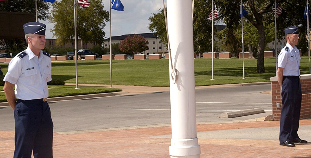 Brig. Gen. Richard Devereaux, 82nd Training Wing commander, and Vice Commander Col. Lansen Conley perform a 10-minute vigil at the wing flag pole Sept. 15. (U.S. Air Force photo/Sandy Wassenmiller)