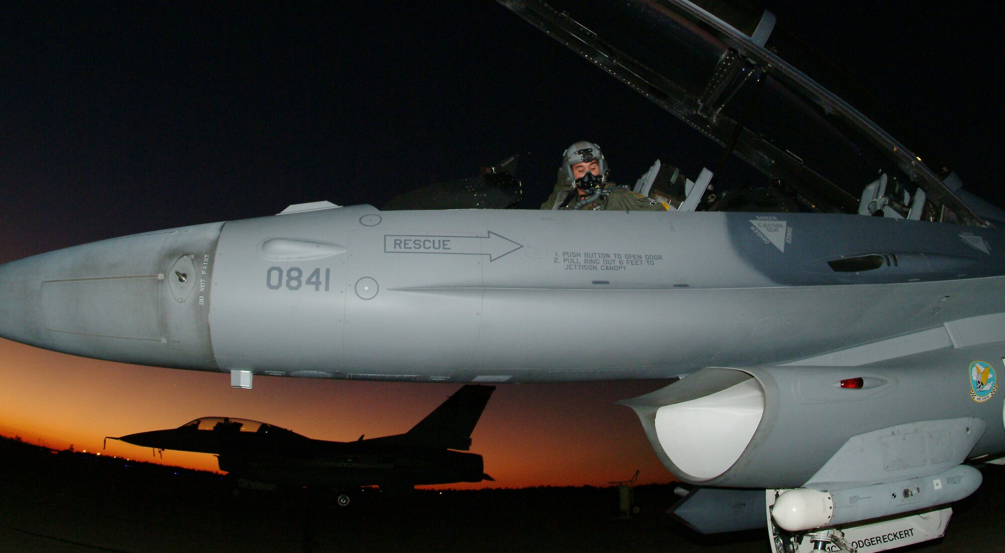Maj. Michael Ferrario, 85th Test and Evaluation Squadron, straps into his F-16 before departing for an Emerald Warrior  sortie Monday.  The 85th TES provided close-air support and air-to-air roles for exercise participants from Hurlburt Field and Eglin,  and approximately 400 deployed U.S. and coalition forces supporting Emerald Warrior 07, the Air Force Special Operations Command’s first joint coalition exercise Oct. 23 to Nov. 3.  (U.S. Air Force photo by Staff Sgt. Samuel King Jr.)