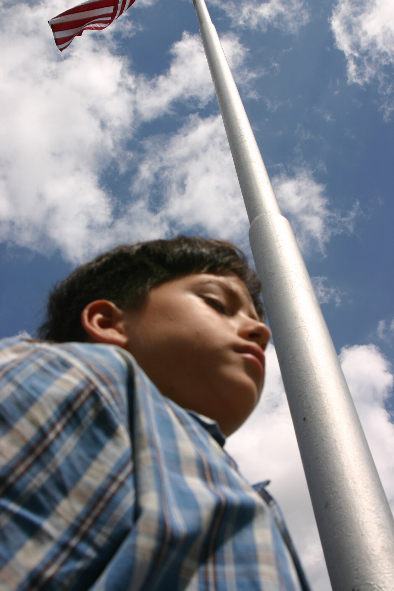 Crhys Meza stand at attention at the Sheppard Elementary School flag pole vigil Sept. 15 in respect to Prisoners-of-War and those Missing in Action. Pairs of students took turns during the shcool's annual vigil that coincides with POW/MIA Day. (U.S. Air Force photo/Airman Jacob Corbin)