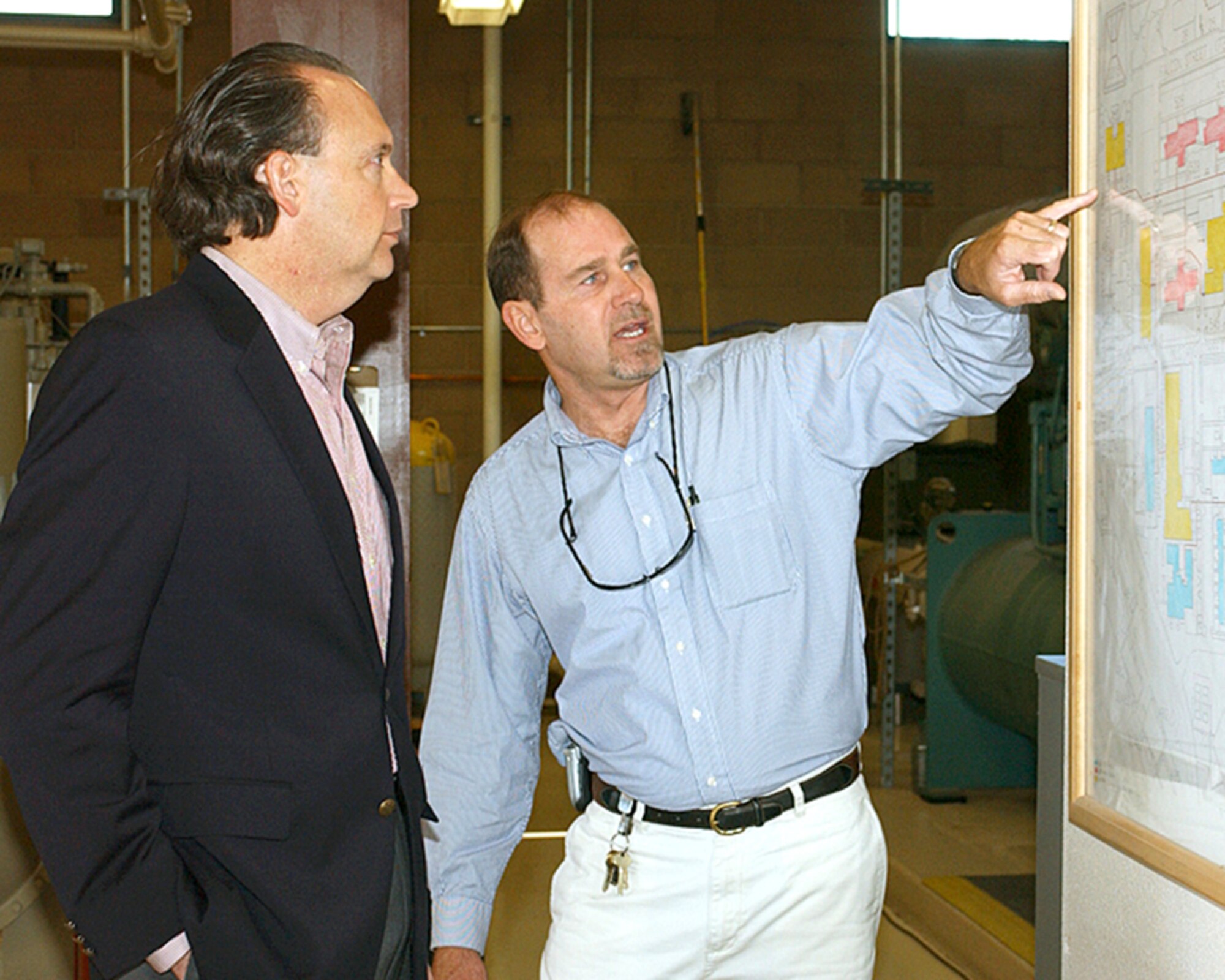 Brian Fisher explains the upgrades on the central chiller plant at Luke Air Force Base, Ariz., to William C. Anderson, Air Force assistant secretary for installations, environment and logistics, on Oct. 26. Mr. Fisher is the 56th Civil Engineer Squadron chief of facility maintenance. (U.S. Air Force photo/Airman 1st Class Gustavo Gonzalez)
