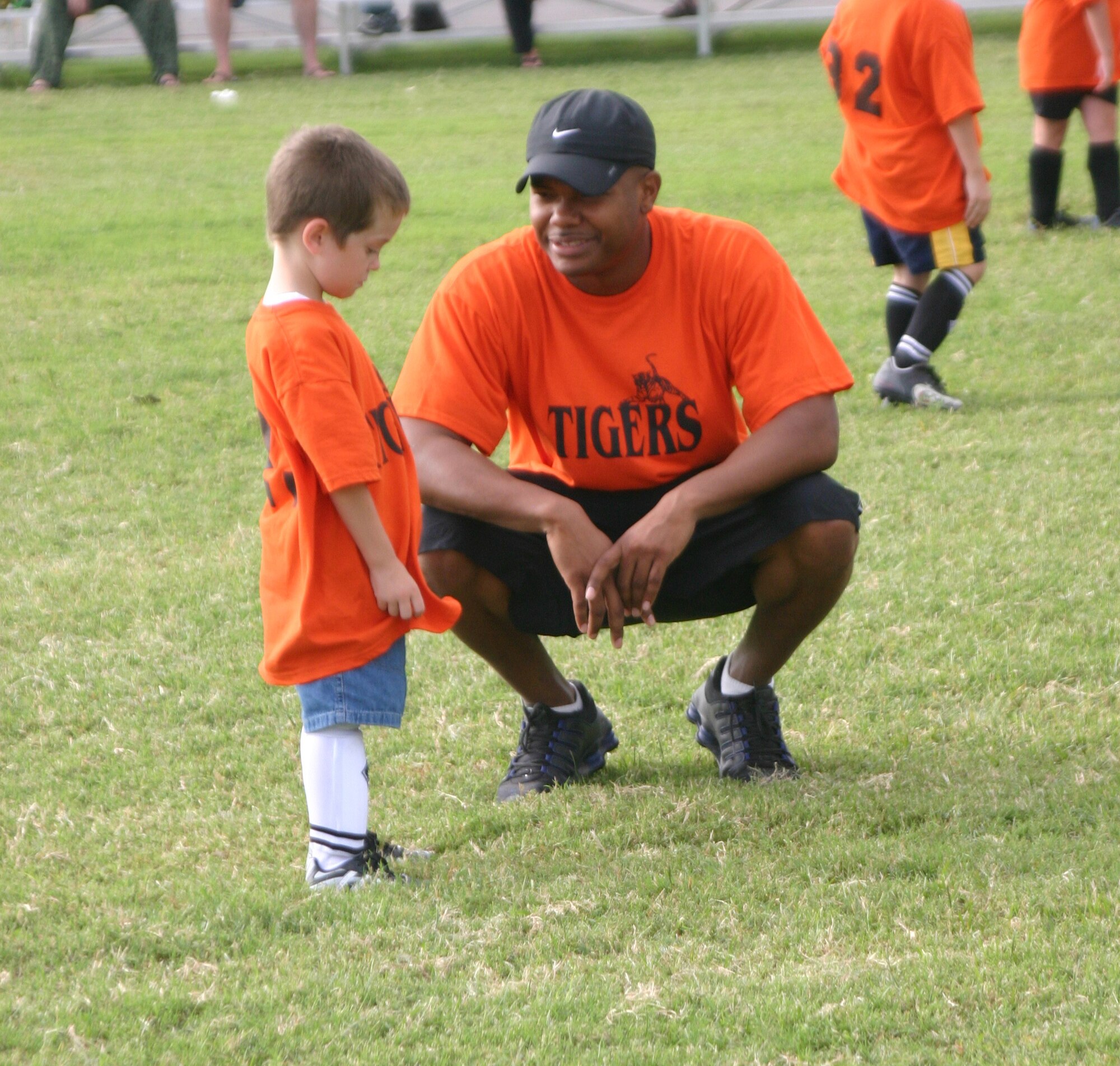 A coach for the Tigers checks with Dylan Matthews to make sure he's not tired and wants to keep playing. (U.S. Air Force photo/Airman Jacob Corbin)