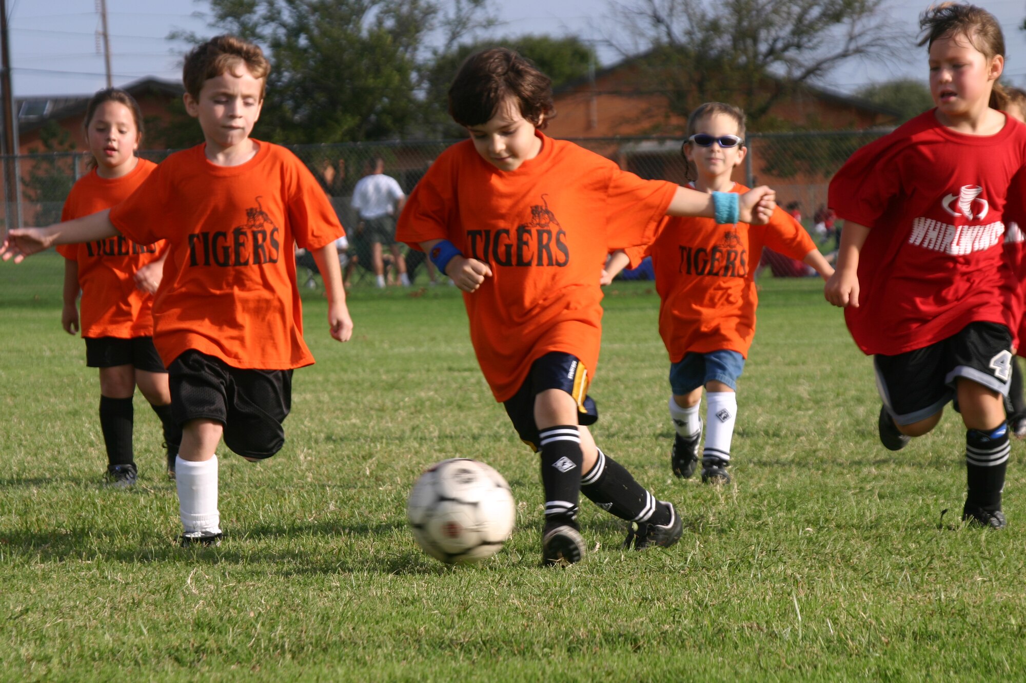 Aidan Bradley guides the ball down the field Sept. 16 at a youth soccer league game between the Tigers and the Whirlwinds. (U.S. Air Force photo/Airman Jacob Corbin)
