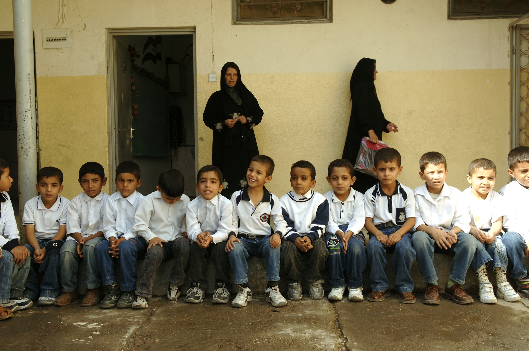 Young Iraqi students wait patiently before being given school supplies at a primary school in the Bayaa District of Baghdad, Iraq, Oct. 31. (U.S. Air Force photo/Master Sgt. Mike Buytas)
