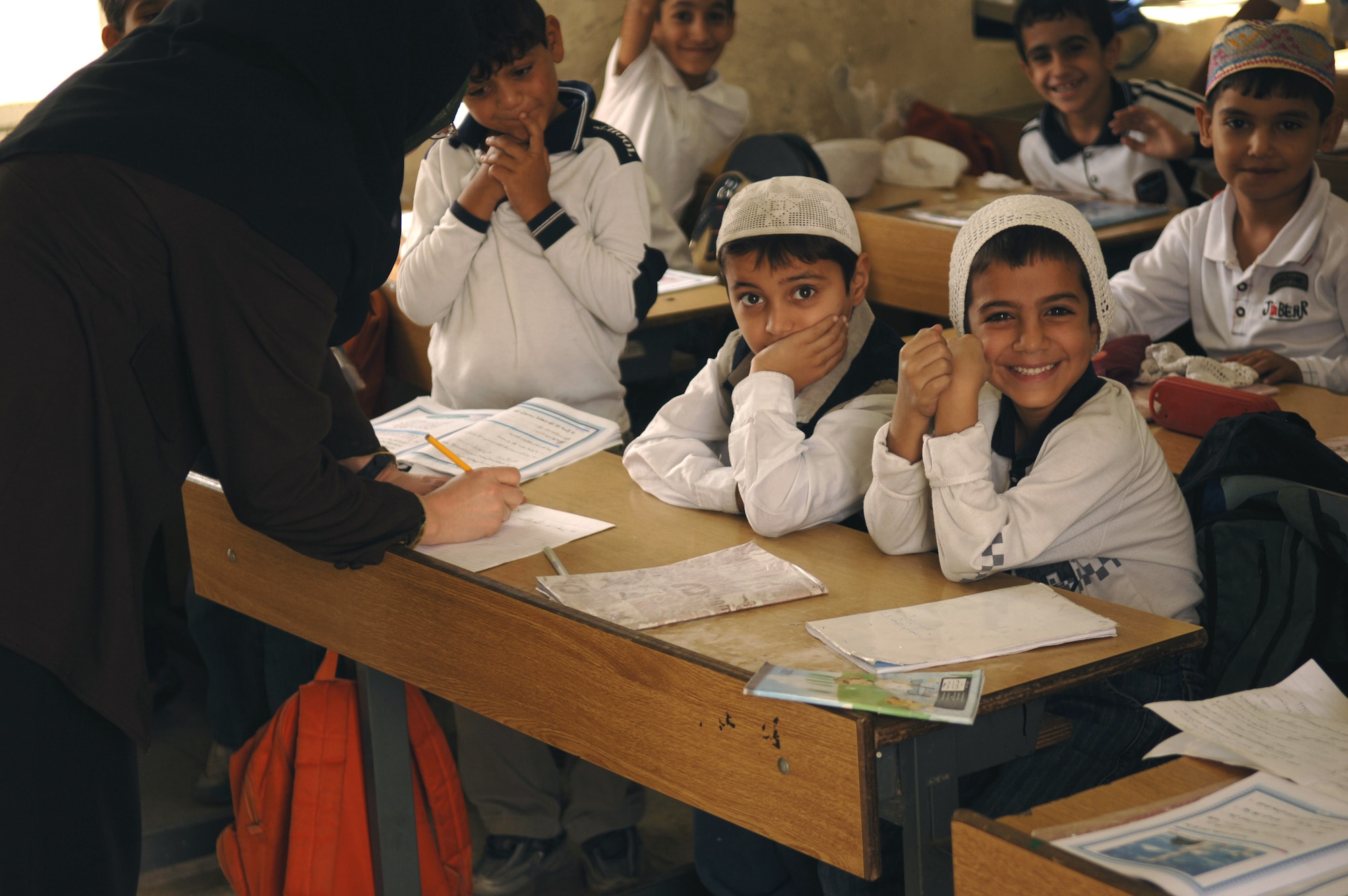 Young Iraqi students await a gift of school supplies in their classroom at a primary school in the Bayaa District of Baghdad, Iraq, Oct. 31. (U.S. Air Force photo/Master Sgt. Mike Buytas)