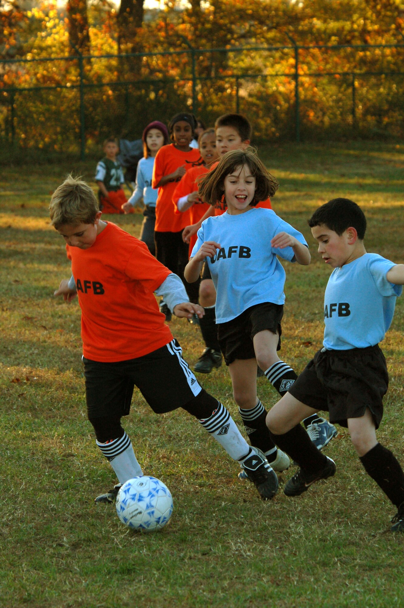DOVER AIR FORCE BASE, Del. -- Caleb Hellman, Dover Air Force Base Youth Center Hurricanes, beats Blake Lundeen, DAFB Youth Center Tigers, to the ball during a match Oct. 26, while Hurricane teammate James MacGregor keeps his eye on the ball. 