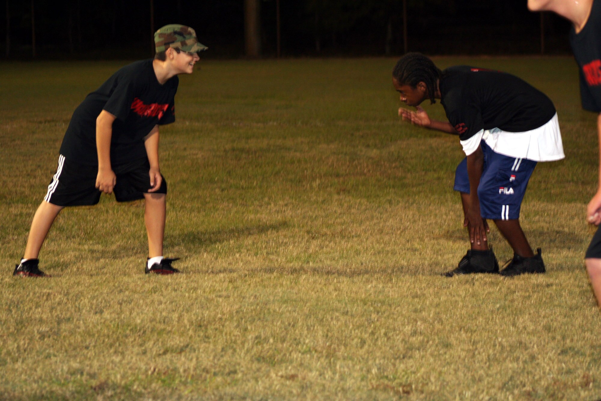 Joel Chastain, left, and Rohan Snyder face-off during scrimmage for the Youth Flag Football League team “the Warriors” at the Community Park here Tues. They will play the YMCA team tomorrow at 1 p.m. (U.S. Air Force Photograph by Staff Sgt. Kelly Ogden)