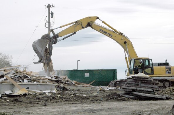 Construction crews work to remove debris from demolished housing units on Washington Circle, behind Lincoln Drive. These units, along with half of thos e on Lincoln Drive, are slated for replacement during Phase A of the sixth stage of the housing replacement project here. The remaining units on Lincoln Drive will be destroyed and replaced during Phase B.