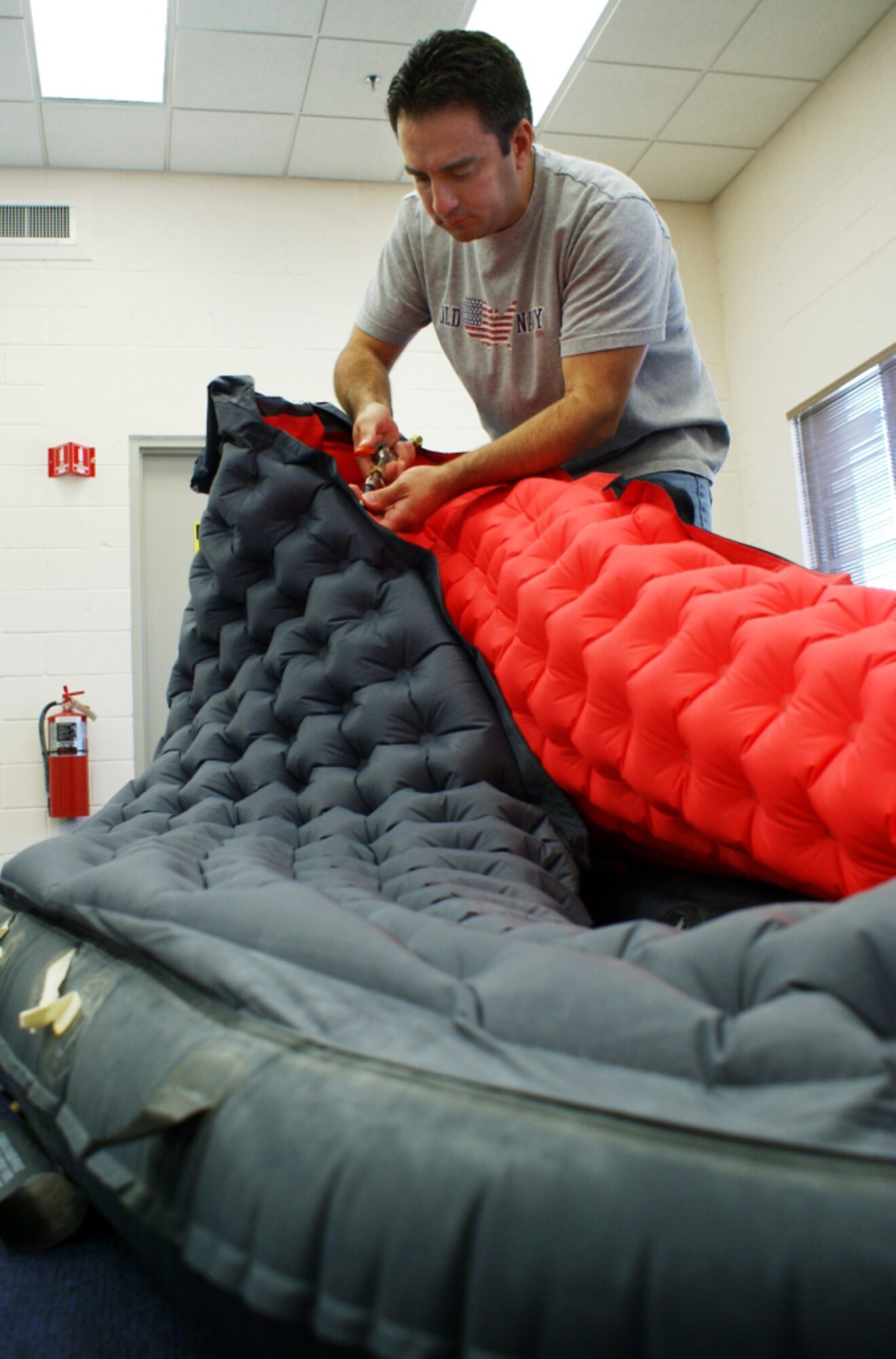 Frank Saldarriaga, an Air Reserve Technician and Master Sergeant in the Air Force Reserve, inflates a one-person survival raft for a six-hour inflation test on Sep. 22. Saldarriaga is a survival equipment specialist and NCO in charge of the Survival Equipment Shop here at Homestead Air Reserve Base, Fla. (Air Force photo by Dan Galindo)