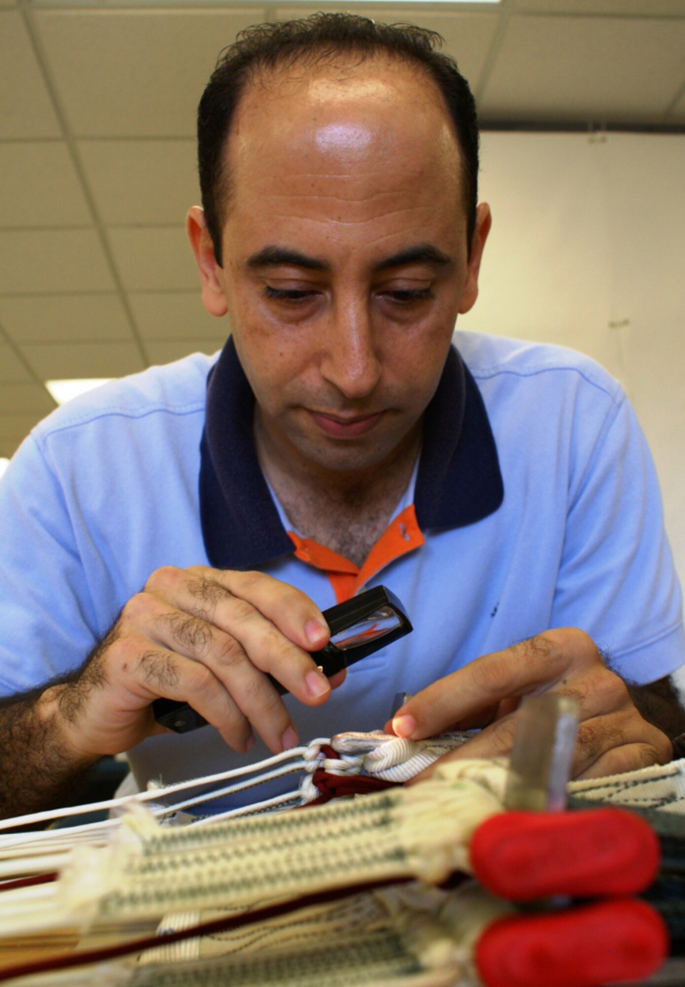 Khalid Bensitel, an Air Reserve Technician and Senior Airman in the Air Force Reserve, inspects the stitching on a parachute prior to packing the chute on Sep. 22. Bensitel is a survival equipment specialist here at Homestead Air Reserve Base, Fla. (Air Force photo by Dan Galindo)