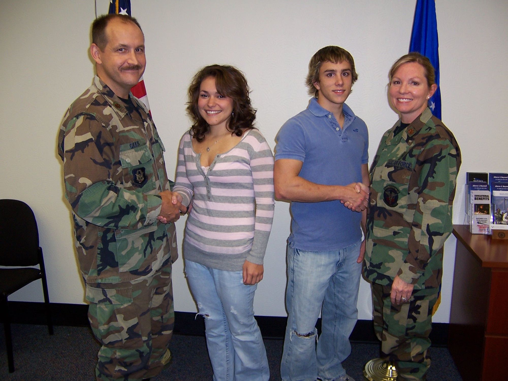 Maj. Mark Geer poses with his daugher, Kasie, and Josh Amburn poses with his mother, Maj. Susan Geer, after both children enlisted in the Reserve Monday, Oct. 23, at the recruiting station on Mansfield Road in Shreveport, La. Majors Mark and Susan Geer are both members of the 917th Wing. (U.S. Air Force courtesy photo)