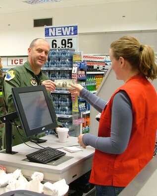 Col. Monty Brock, 31st Fighter Wing vice commander, makes the first purchase at Aviano’s new shoppette in the flightline area. 
The shoppette is open Mondays through Thursdays from 6 a.m. to 10 p.m., Fridays from 6 a.m. to midnight, Saturdays from 8 a.m. to midnight, and Sundays from 8 a.m. to 10 p.m. (Photo by Senior Airman Colleen Wieman)