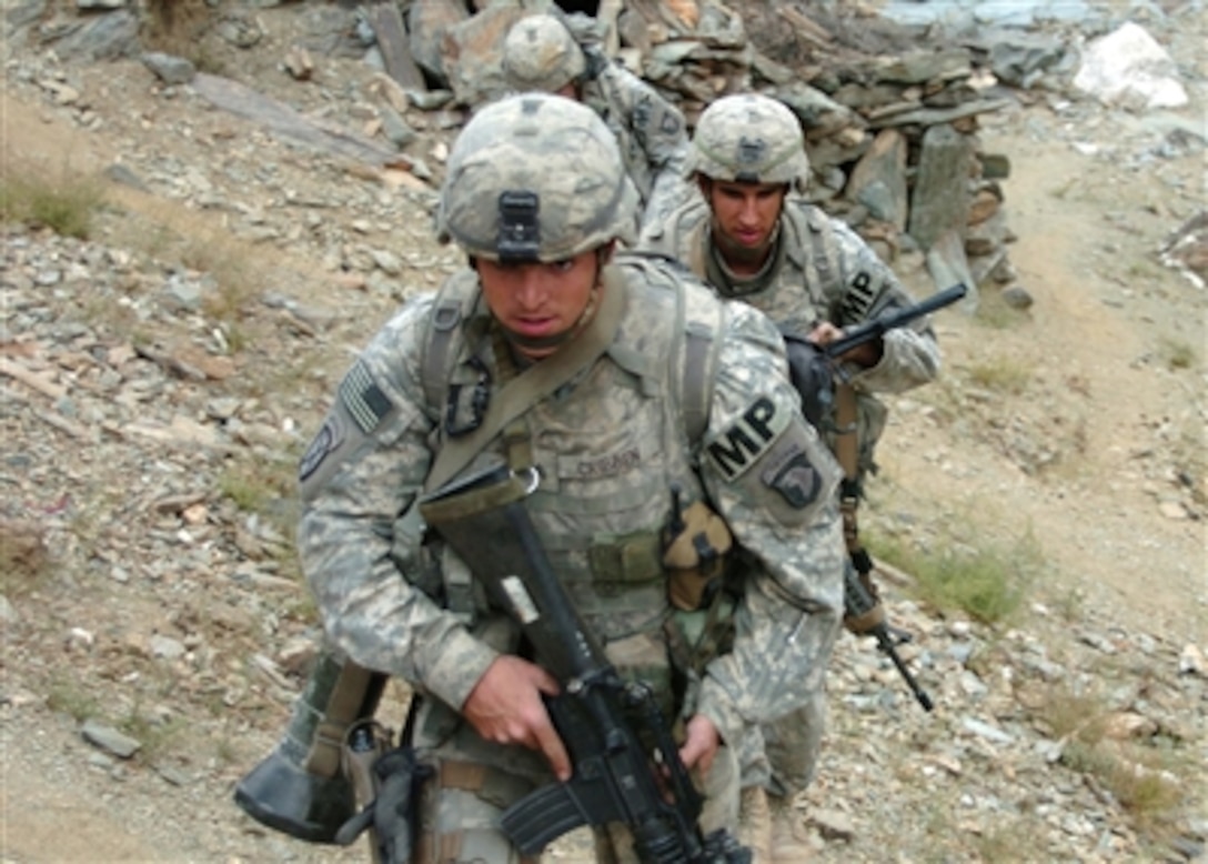 U.S. Army Sgt. Stephen Cribben leads Spcs. Casey Russel and Timothy Harris,  561st Military Police Company, Fort Campbell, Ky., and attached to the 10th Mountain Division, up a hill to provide security for fellow soldiers who are waiting for a maintenance team in Parwan Province, Afghanistan, Oct. 25, 2006. 