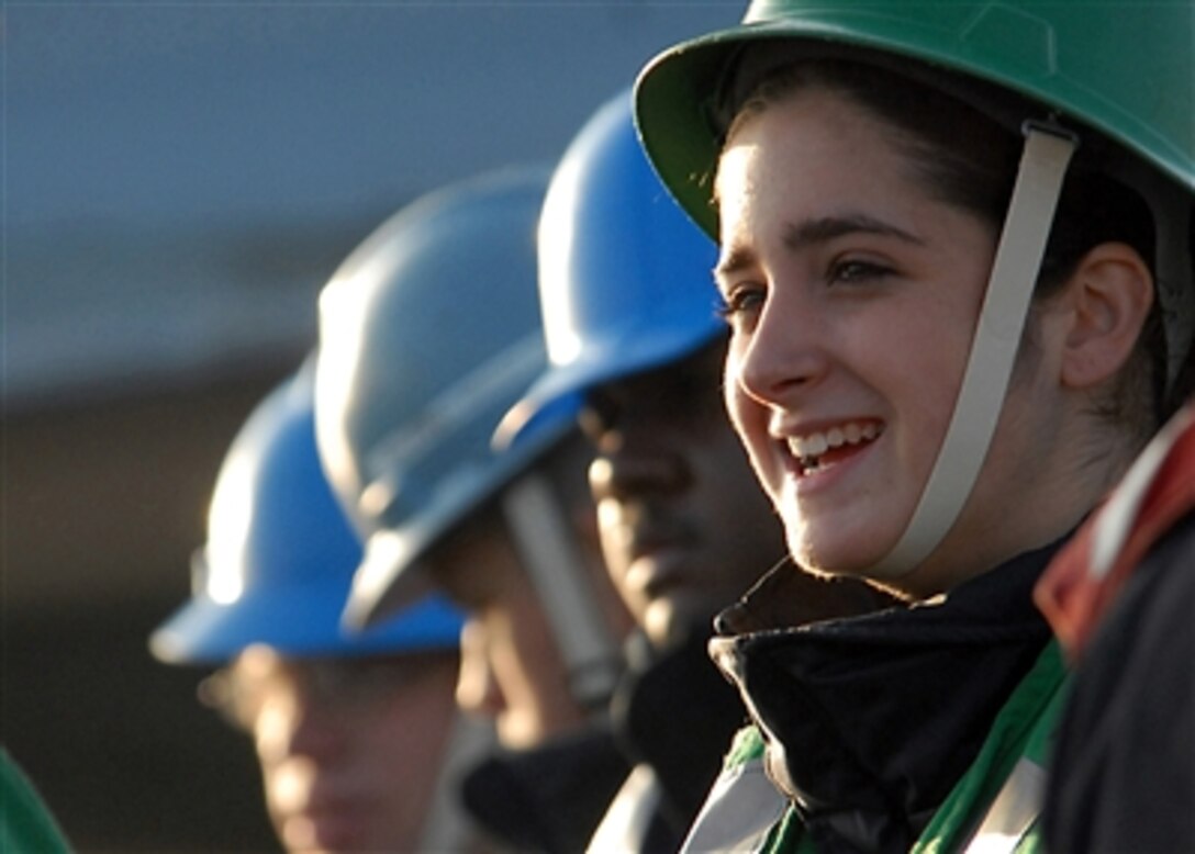 Seaman Ashley Kolbinskie lines up with other crewmembers aboard the USS Ronald Reagan (CVN 76) as they wait for the start of replenishment at sea with the USNS Guadalupe (T-AO 200) in the Pacific Ocean on Oct. 26, 2006.  The Reagan is conducting carrier qualifications off the coast of Southern California.  