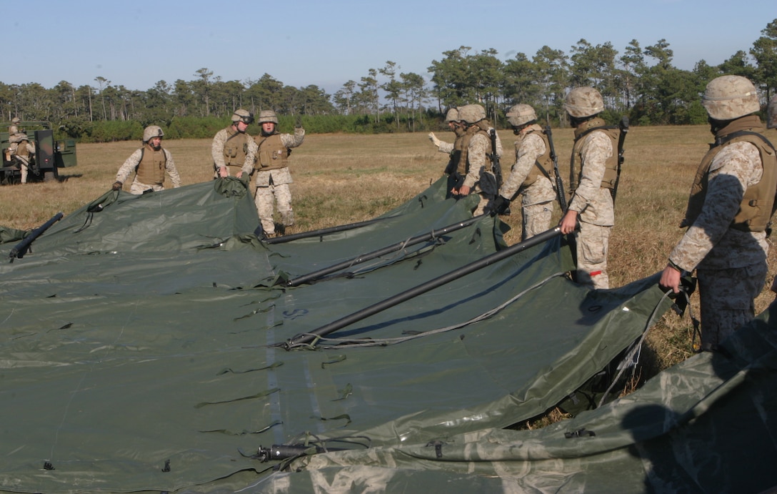 Marines from the 26th Marine Expeditionary Unit's Combat Logistics Battalion-26 build tents to house displaced persons during a humanitarian assistance drill, Nov 4, 2006.  The II Marine Expeditionary Forces Special Operations Training Group graded the CLB-26 on its proficiency in building the camp and managing the affected population who would use the facility after its construction.