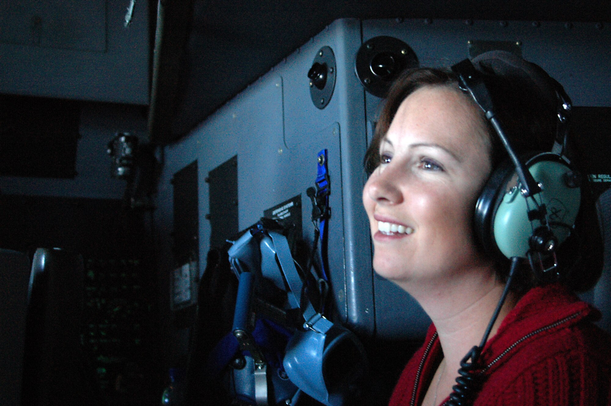 Jenny Cullinan, a representative of Cellular South, enjoys an orientation flight from the flight deck of a WC-130J during the 403rd Wing's annual Employer Day. This aircraft is used by the Hurricane Hunters of the 53rd Weather Reconnaissance Squadron to gather critical weather data used by forecasters at the National Hurricane Center.