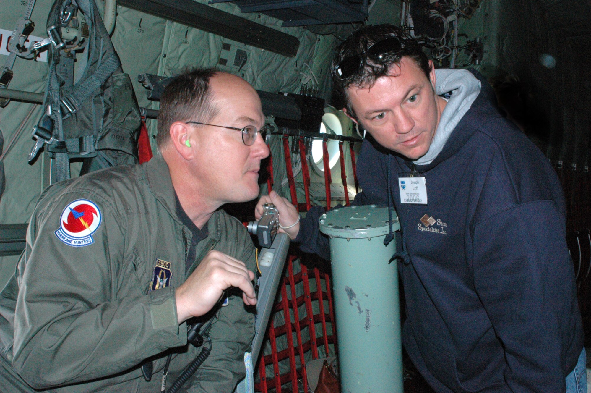 Master Sgt. Tony Hlavac, a weather reconnaissance loadmaster, with the 53rd Weather Reconnaissance Squadron, explains how he collects weather data aboard a WC-130J Hurricane Hunter aircraft to employer Joseph Lott of Stone Specialties Inc. The 53rd is one of two flying squadrons assigned to the 403rd Wing, an Air Force Reserve Command unit made up of more than 1,400 Reservists and stationed at Keesler Air Force Base, Miss.