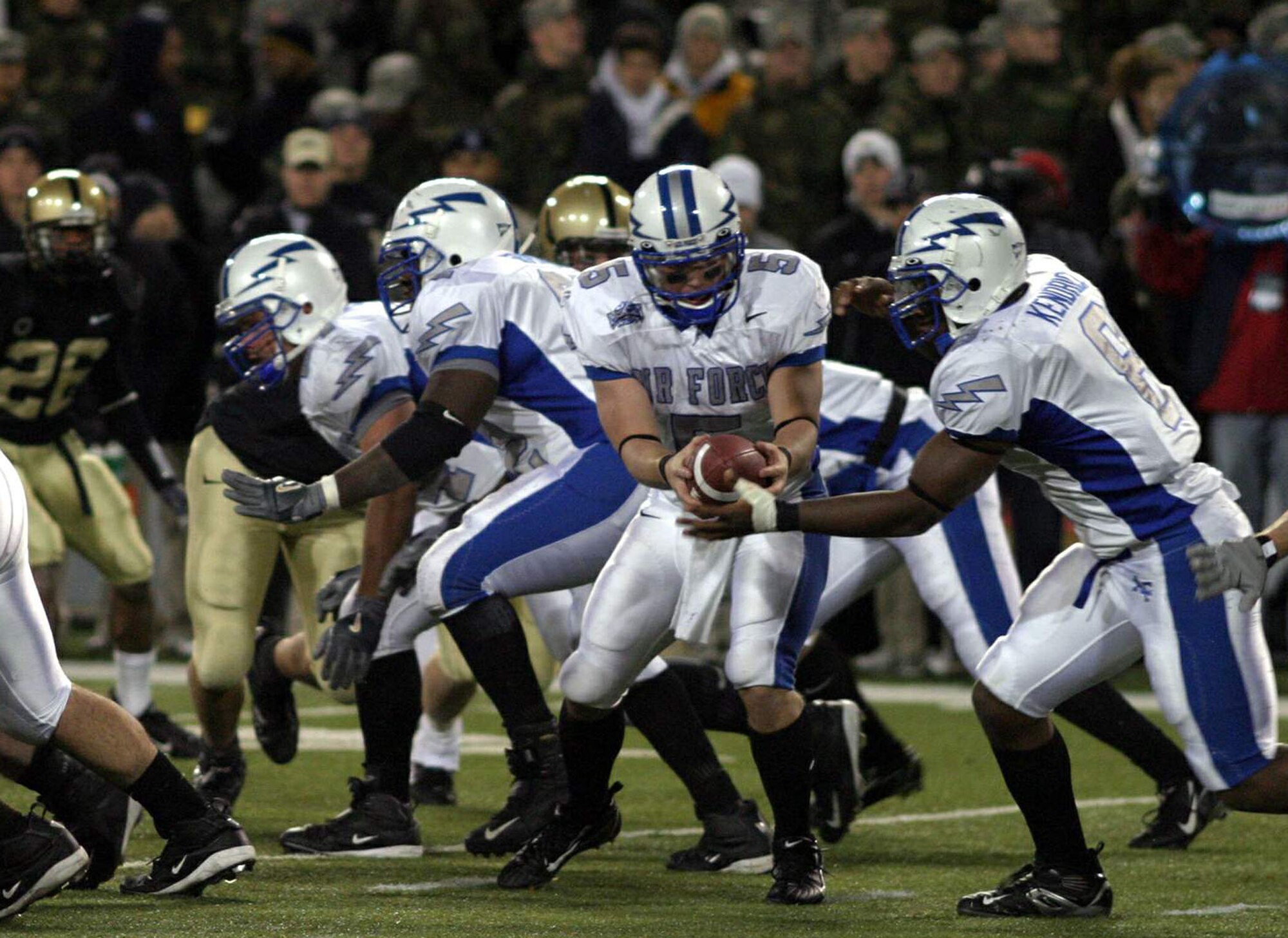 Air Force quarterback Shaun Carney hands off to fullback Jacobe Kendrick who eyes the offensive line moving Army back Nov.3 at West Point, N.Y., where Air Force prevailed 43-7. (U.S. Air Force Photo/Ken Carter)
