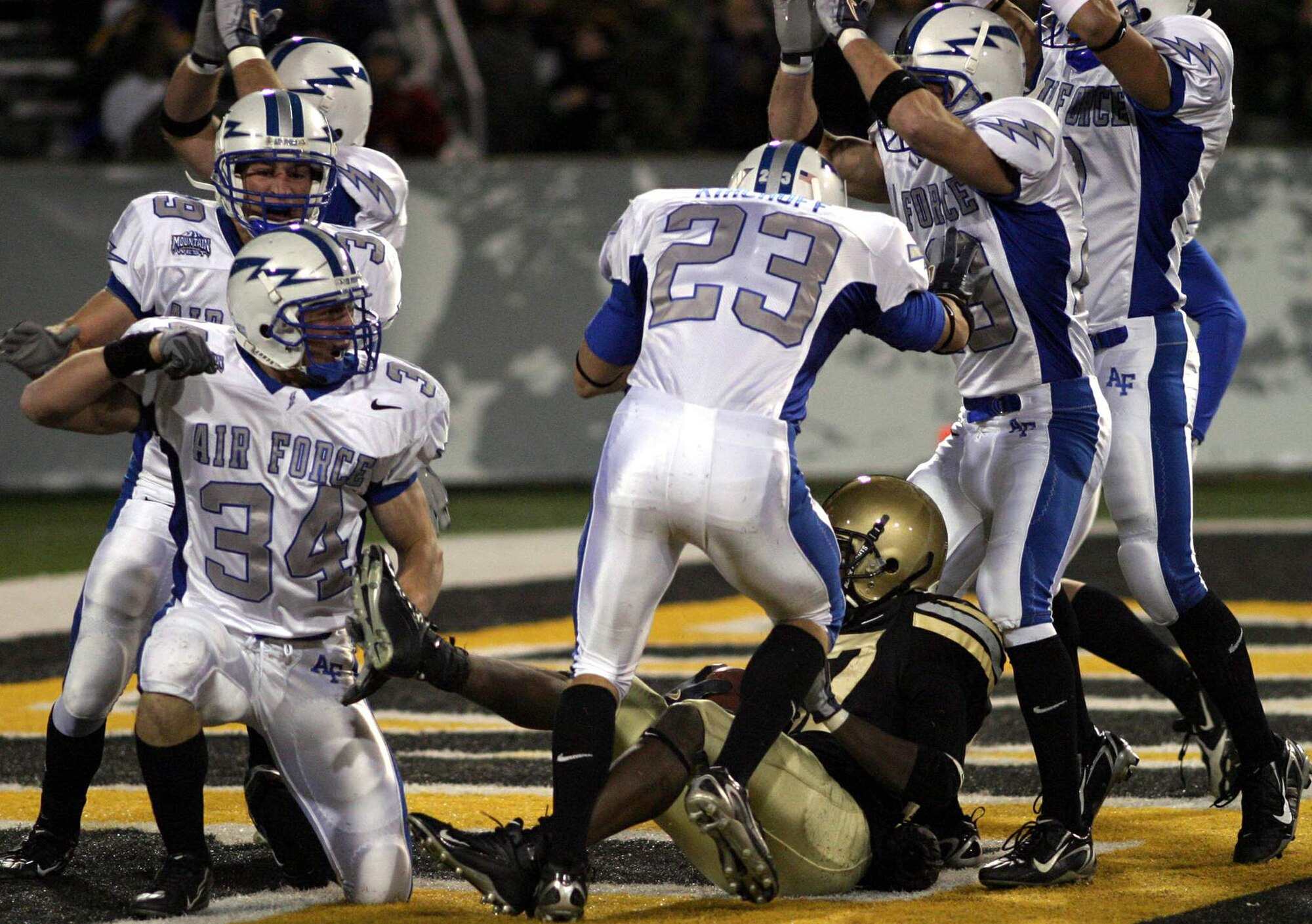 Falcon special team players Chris Thomas, 34, Aaron Kirchoff, 23, and others, celebrate the safety they scored by tackling Army's Damion Hunter in the end zone Nov. 3 at West Point, N.Y. (U.S. Air Force Photo/Ken Carter)