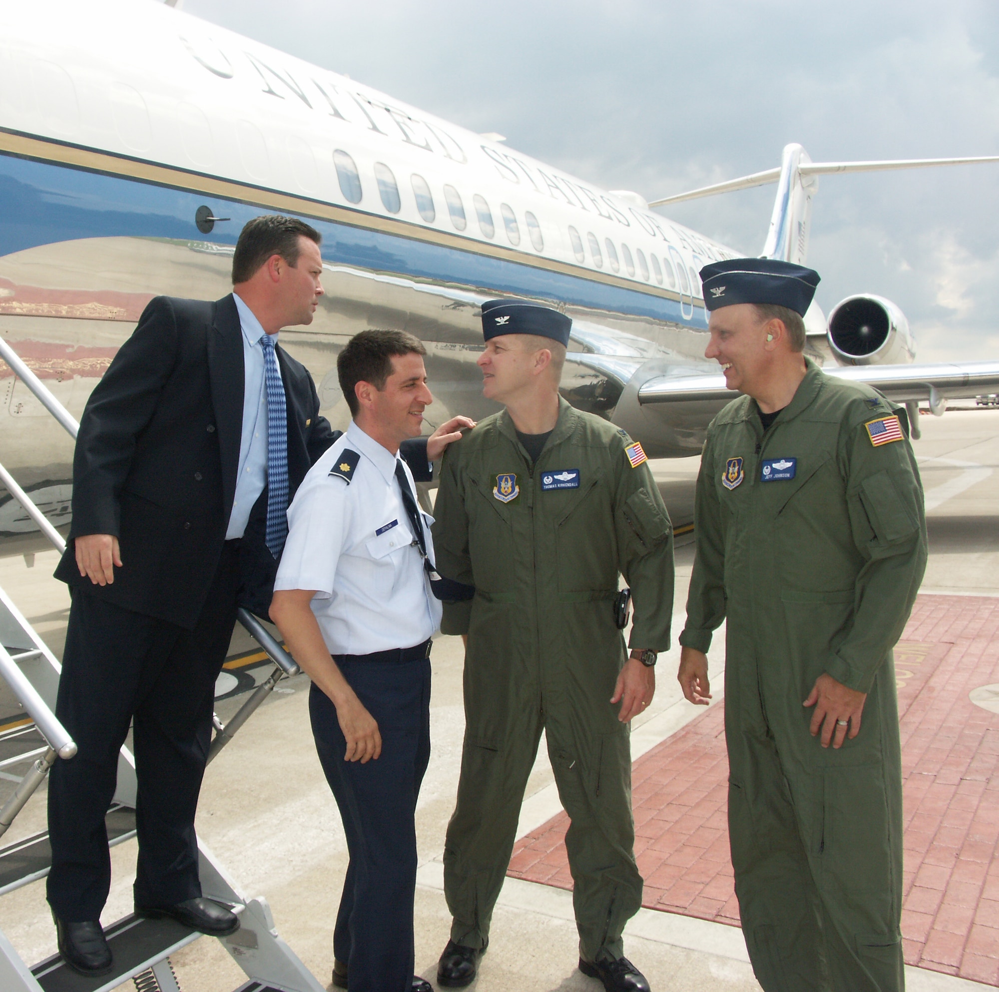 Master Sgt. James Gallagher, flight attendant at the 932nd Airlift Wing, gives a quick after flight briefing to Col. Thomas Kirkendall at Scott Air Force Base.