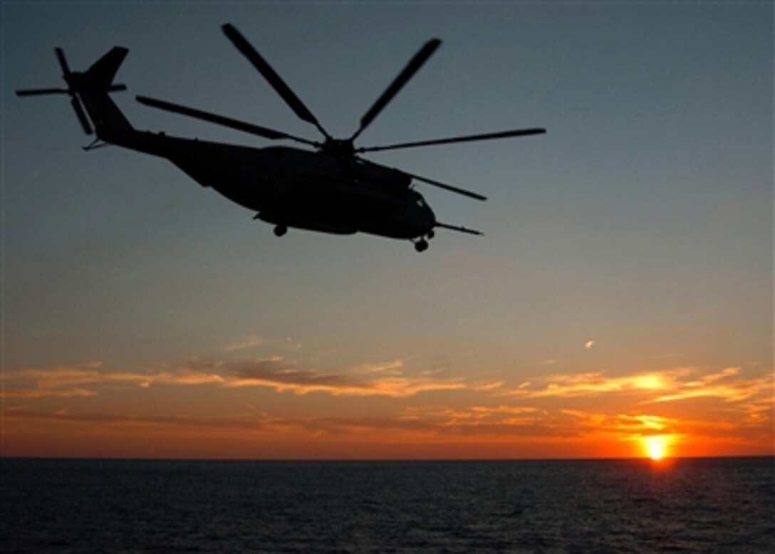 An CH-53E Sea Stallion helicopter leaves the flight deck of the amphibious docking ship USS Shreveport, Oct. 25, 2006.