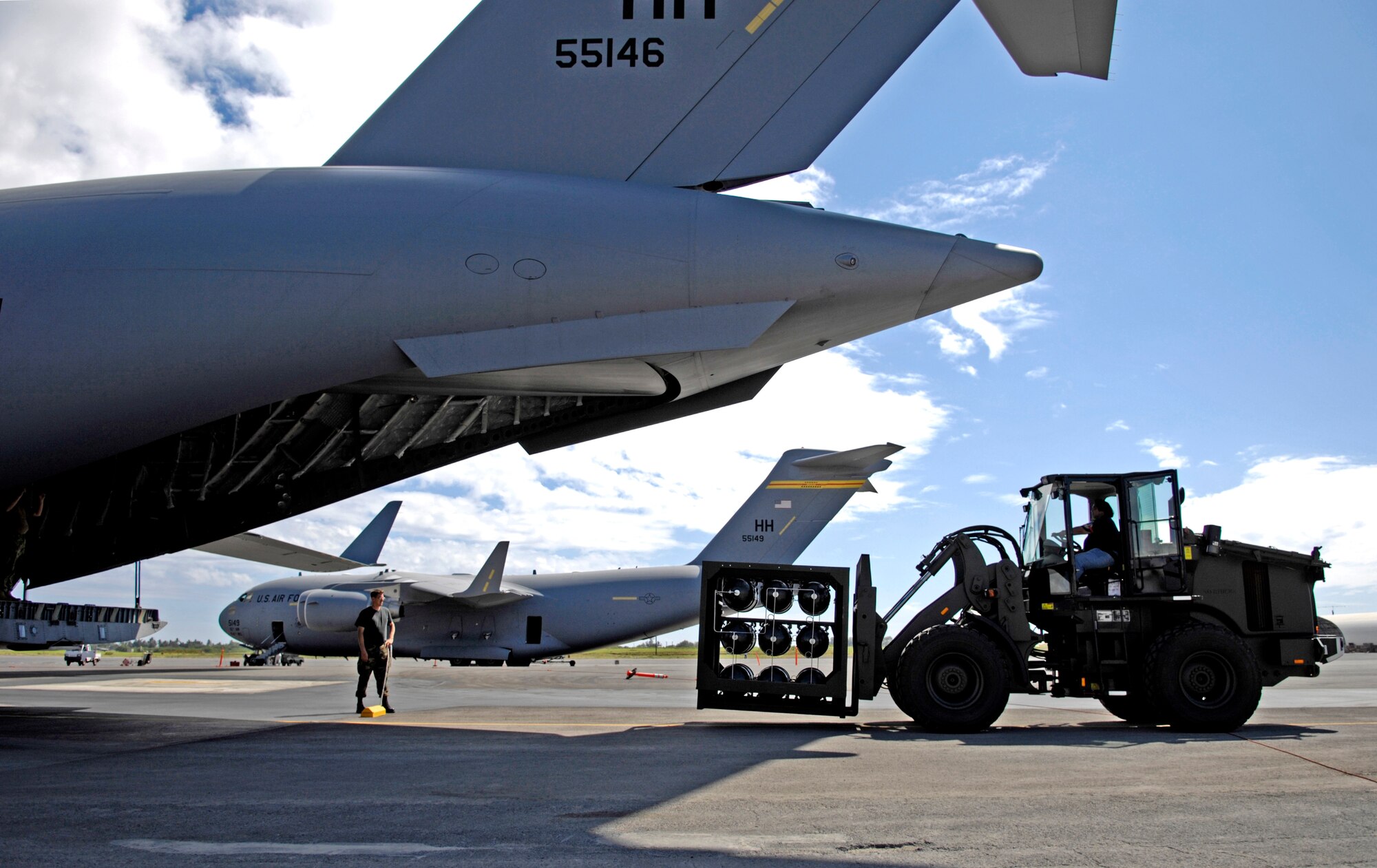 The HydraFLX System is brought up to the back end of a C-17 Globemaster III to demonstrate its mobile capability at Hickam Air Force Base, Hawaii Oct. 18, 2006. The HydraFLX System is being tested by the Air Force as an alternate energy source. It will generate ultra-pure H2 (hydrogen) from water in a flexible pressure management process for fueling buses, tow-tractors, vans, sedans and ground support equipment. The system can also be deployed anywhere and operate in hostile theaters without infrastructure or pipelines. 