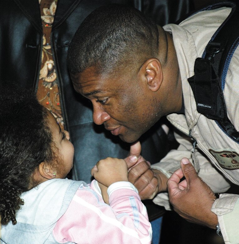 Master Sgt. Tony Pemberton greets his daughter Kyra, 4, at Pope Air Force Base, N.C., after returning from deployment to Southwest Asia. (U.S. Air Force photo/Senior Airman Cassandra Locke)