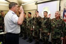Major General Robert E. Duignan, 4th Air Force commander, conducts a mass re-enlistment for the 349th Air Mobility Command members at Travis Air Force Base, Calif. 
(Travis AFB, CA, Released)