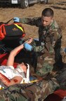 Tech. Sgt. Edward Rodriguez, an Independent Duty Medical Technician from the 60th Medical Squadron, checks the vital signs of victim Senior Airman Morgan Cockran, member of the 60th Medical Operation Squadron during Exercise "Aircraft Down," a joint exercise between Travis Air Force Base, Calif., and the surrounding local community first responders held Oct. 19. The exercise simulated a C-5 Galaxy crash. More than 350 people and 32 off-base agencies took part in the exercise. 
(Travis Air Force Base, Calif. Released)