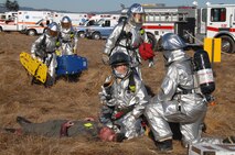 Firefighters from Travis Air Force Base, Calif., tend to victims during a simulated aircraft accident. Travis and the local community united to test their teamwork skills during Exercise "Aircraft Down" held Oct. 19. 
(Travis AFB, Calif., Released)