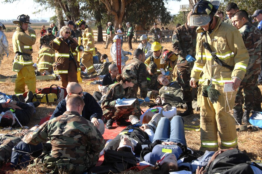 First responders tend to the "victims" of a simulated C-5 Galaxy crash during Exercise "Aircraft Down," a joint exercise between Travis Air Force Base, Calif., and the surrounding community. More than 350 people and 32 off-base agencies took part in the exercise held Oct 19.
(Travis AFB, CA, Released)
