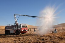 A crash fire truck from Travis Air Force Base, Calif., shows its readiness by pumping water on the simulated crash site of a C-5 Galaxy during Exercise “Aircraft Down,” a joint exercise between Travis and local community. More than 350 people and 32 off-base agencies took part in the exercise held Oct. 19.
(Travis AFB, Calif., Released)
