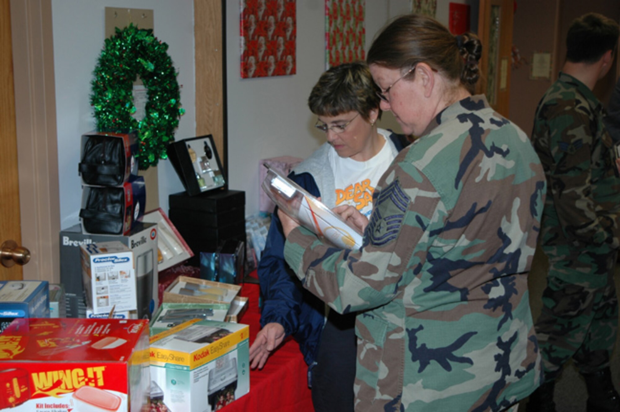 GRISSOM AIR RESERVE BASE, Ind .-- Chief Master Sergeant Diana Rogers browses through the wide selection of items at the Base Exchange Chritmas Store.  The store will be open Nov. 9, 16, 17, 30 and Dec. 1 from 11 am to 2 pm; Dec. 2 from 9 am to 4 pm and Dec. 3 from 10 am to 4 pm.  (U.S. Air Force photo/Senior Airman Chris Bolen)